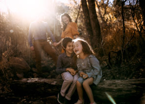 family in bright light in the woods