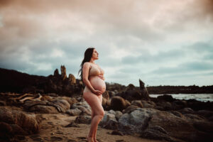 maternity women in california rocky beach in nude clothing