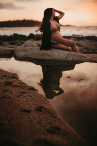 Maternity session with reflection in the water of mama and her belly